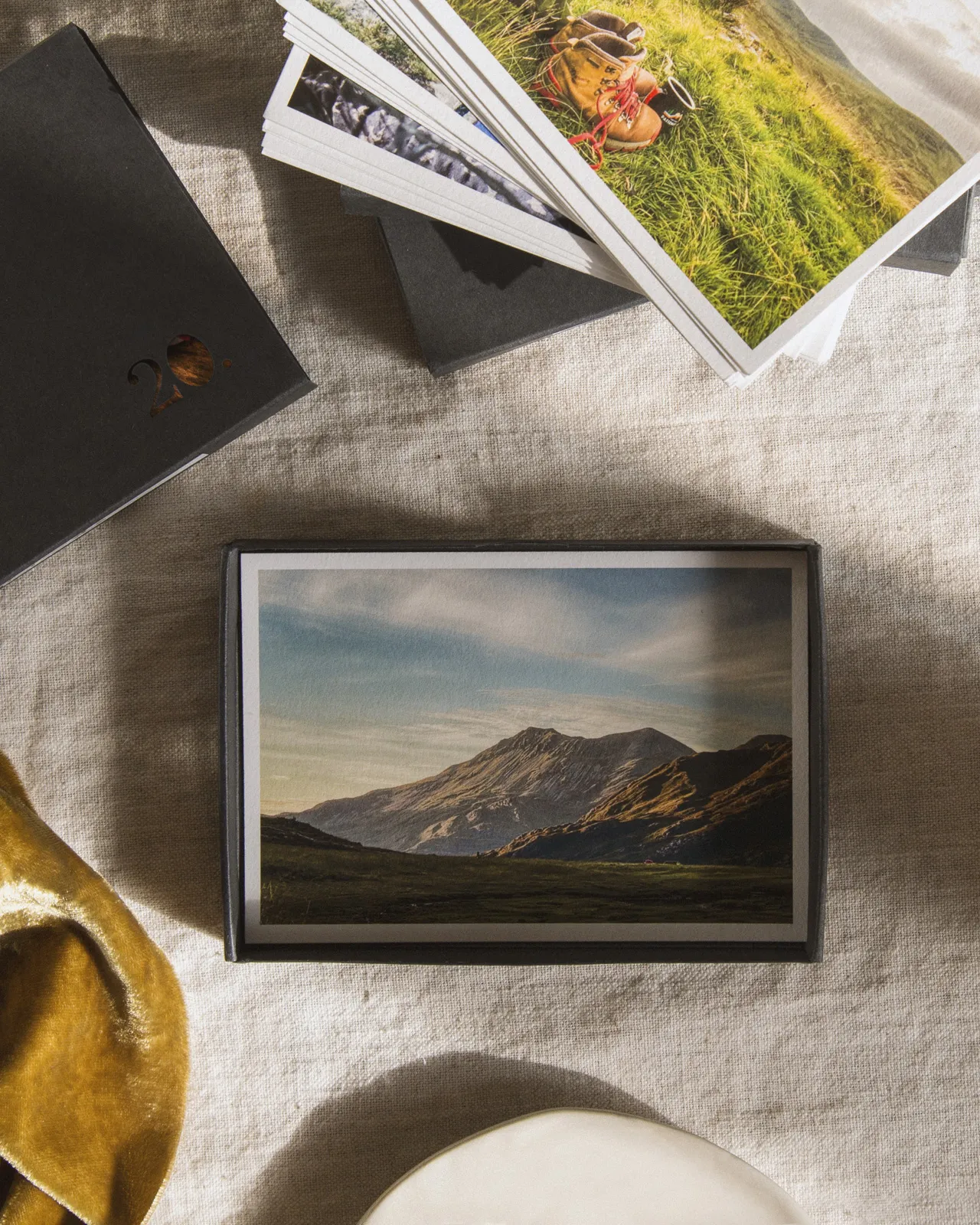 A finished box of printed photographs laid out on linen
