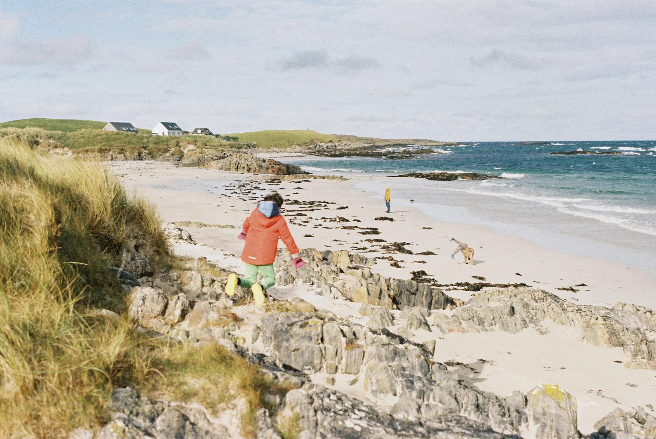 A child jumping down towards a beach